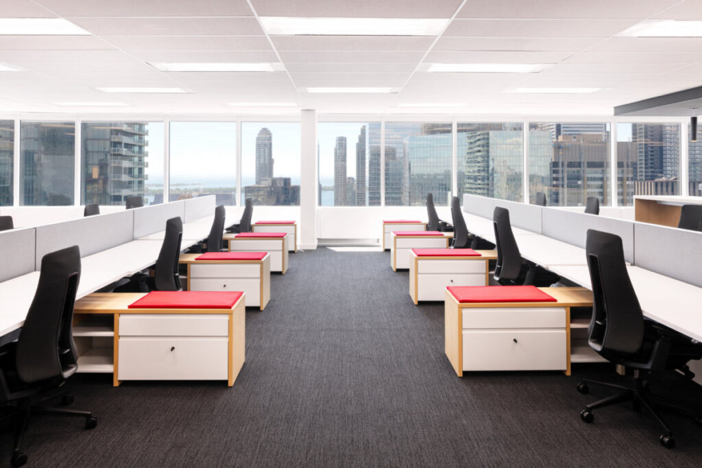canadian-olympic-committee-image-1 Two rows of desks with office chairs and cabinets
