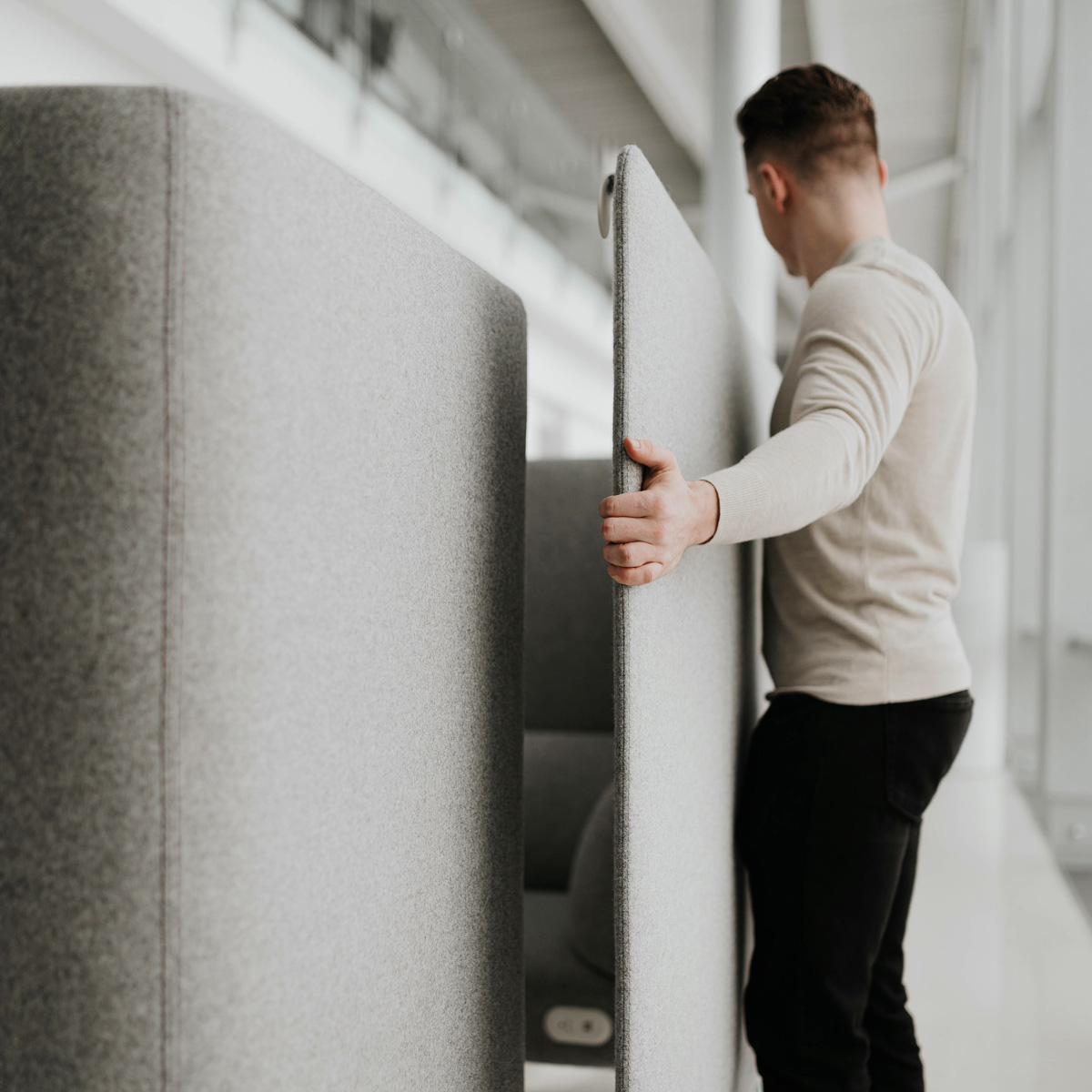 ipd Person moving a piece of a cubicle