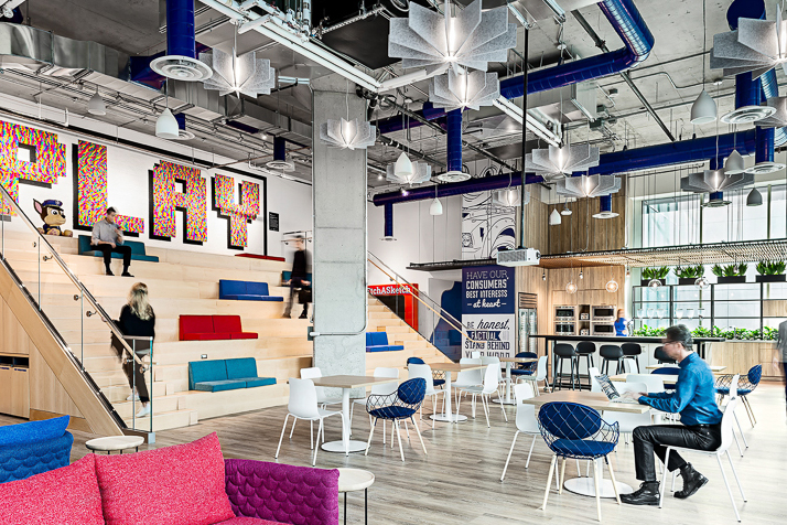 spin-master-card Large office space with tables and staircase seating