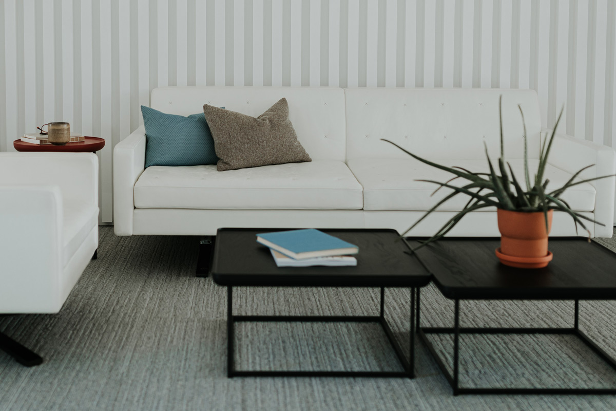 A couch and two tables on raised flooring